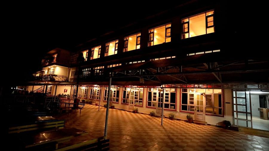 Facade of Amara Hill Queen, Mussoorie at night with the lights turned on.