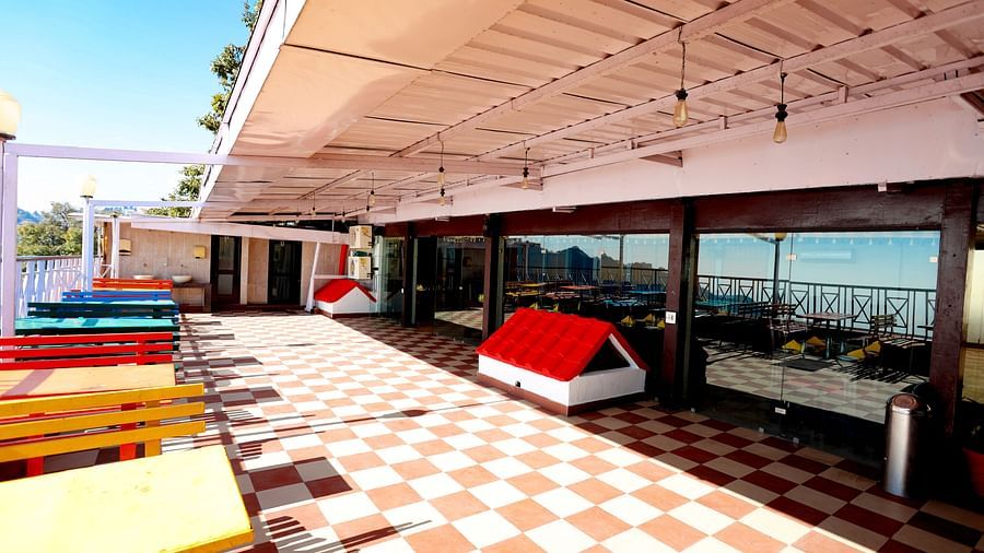 Image of an outdoor seating area with tables and benches at Amara Hill Queen, Mussoorie 