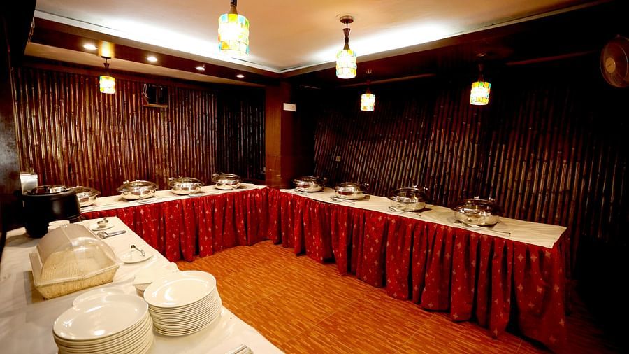 Image of a u-shaped buffet table with crockery arranged on the table at Amara Hill Queen, Mussoorie.