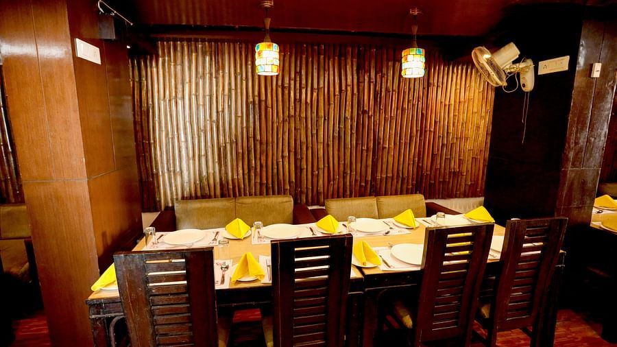 Image of a dining space with a table and a chairs around it at Amara Hill Queen, Mussoorie.