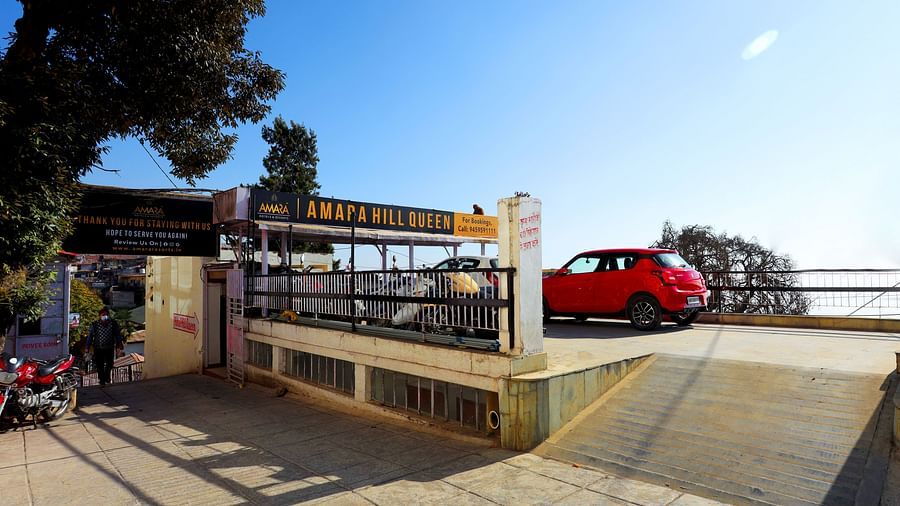 Image of the driveway at Amara Hill Queen, Mussoorie with a car parked outside.