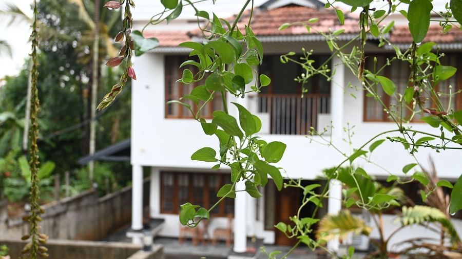 Facade of Ananda Holiday Home in Wayanad peeking from a vine