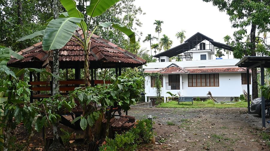 View of the Facade of Ananda Holiday Home in Wayanad along with a gazebo outside between the greens