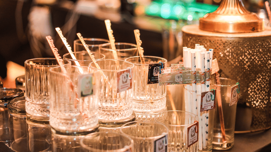 A drink station with glasses, straws and beverage containers at Ananta Spa and Resort, Jaipur