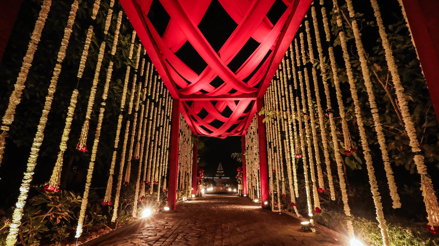An entrance tunnel with a tall overhead structure and pathway lighting at Ananta Spa and Resort, Jaipur