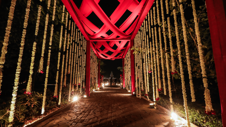 An entrance walkway with a tall overhead structure and lighting at Ananta Spa and Resort, Jaipur