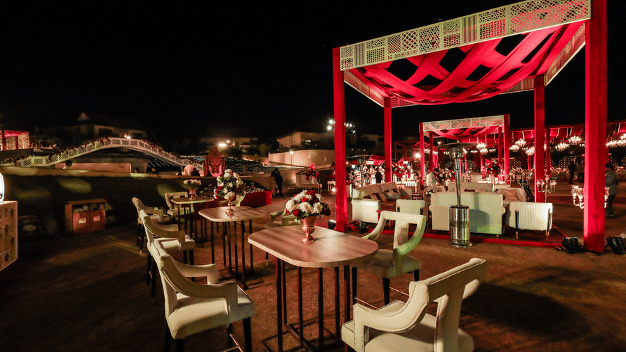An outdoor dining area with tables chairs and an open structure at Ananta Spa and Resort, Jaipur