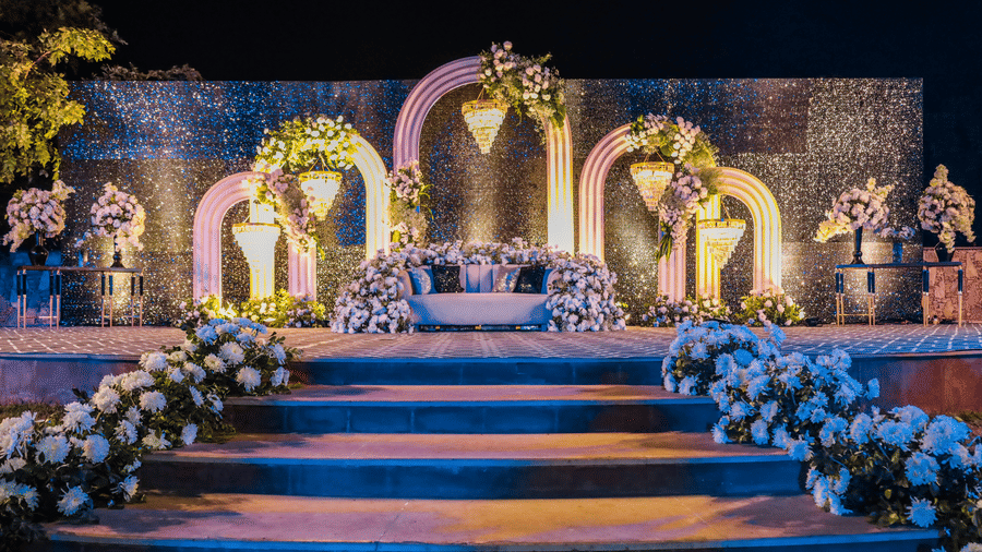 Decorated wedding stage with floral arrangements and arches at Ananta Spa and Resorts, Jaipur.