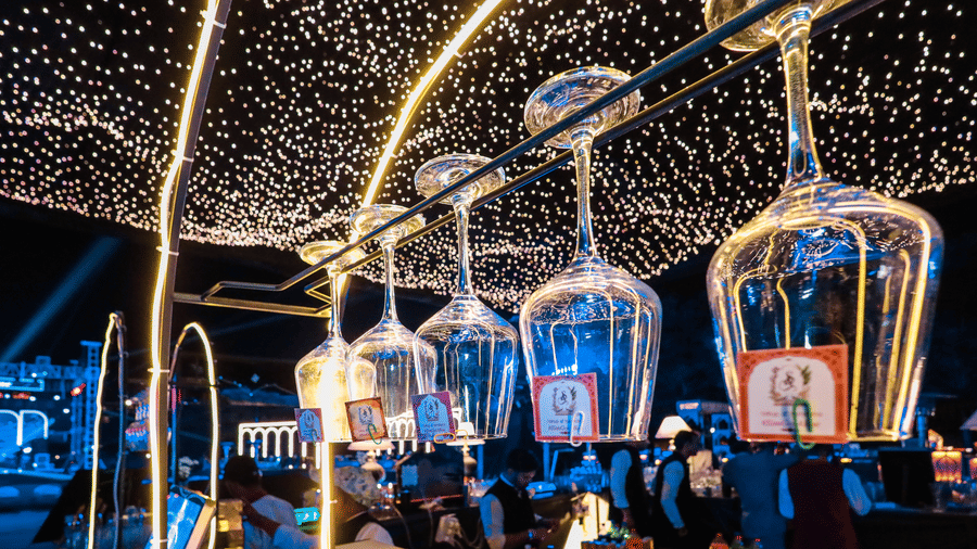 Dining area decorated with string lights and hanging lanterns at Ananta Spa and Resorts, Jaipur.