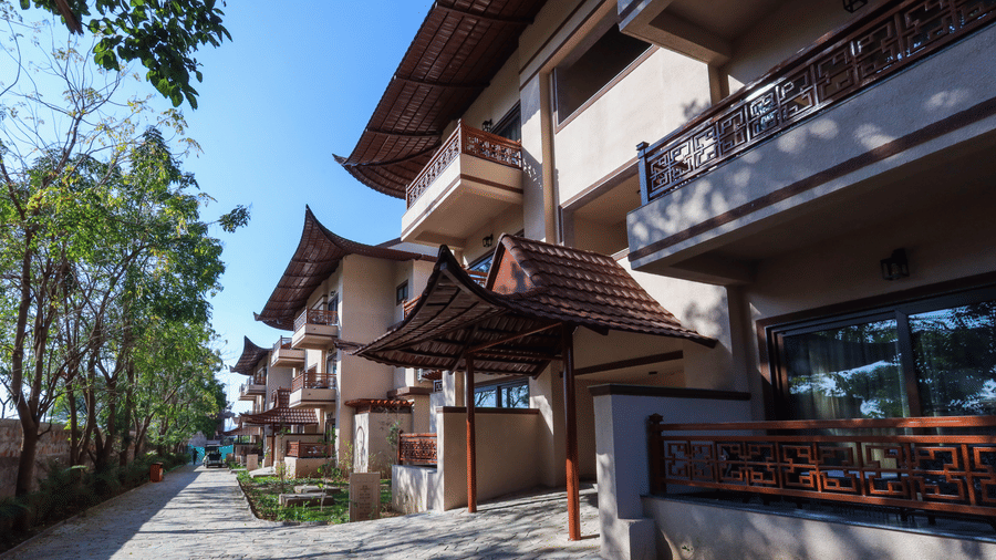 A row of villas with balconies, pathways and plants at Ananta Spa and Resort, Jaipur
