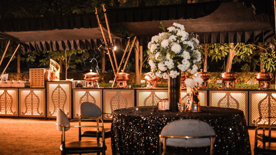 Dining setup with tables, chairs, and floral arrangements at Ananta Spa and Resort, Jaipur.