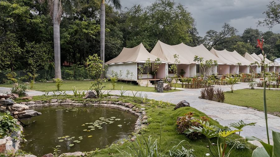 exterior image of the luxury tent villas nestled amidst serene greenery at aranya vilas
