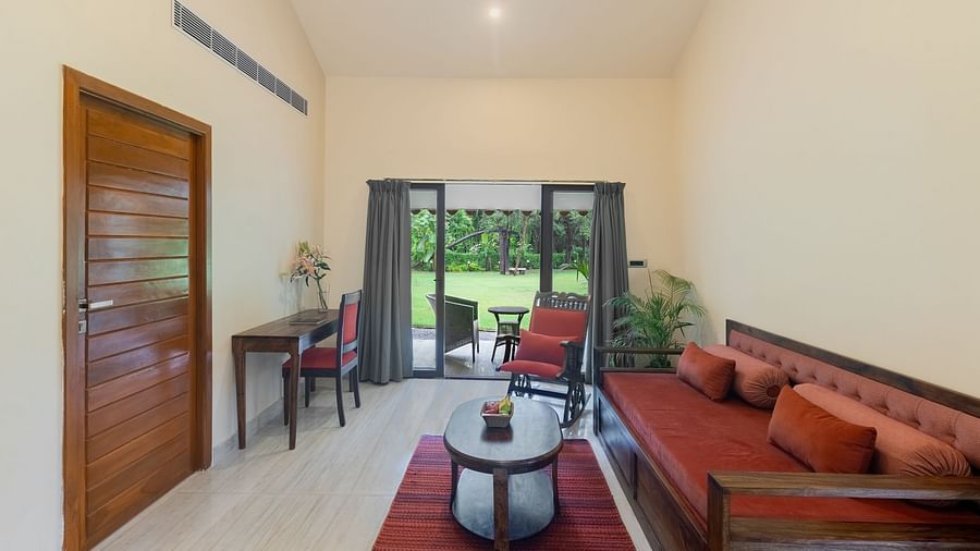 image of the living area from a different angle showcasing the seating area and huge french windows at the far end of the room at our resort in udaipur