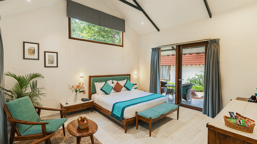 Luxury Villa at Aranya Vilas by Mertia Hospitality featuring a king size bed along with a full sized french windows  and a seating area.
