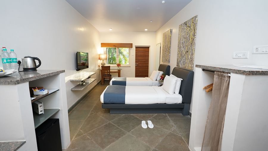 An image of a bedroom with twin beds and other room amenities - Argo By Trance, Goa