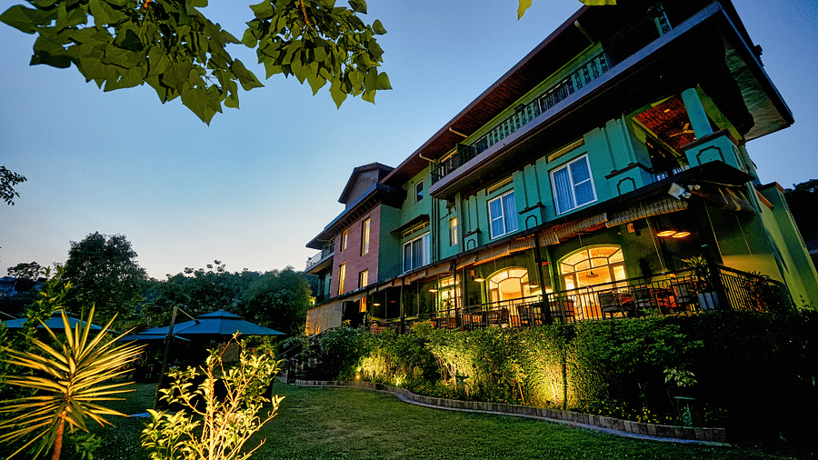 A picture of Atman, Dharamshala luxurious entrance with beautifully lit lighting and lawn area