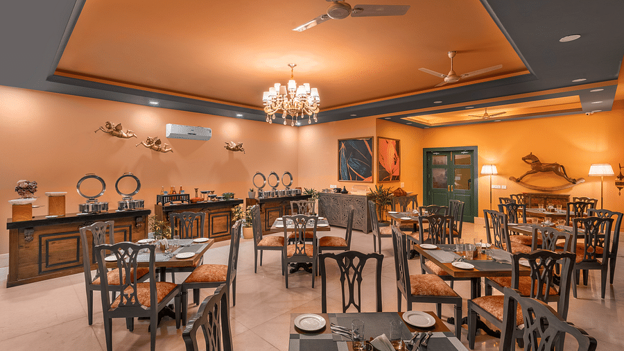 tables and chairs in clusters spread across a room with a buffet setting on the side - Atman, Dharamshala
