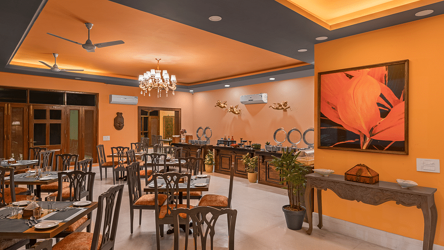 tables and chairs in clusters spread across a room with a buffet setting on the side - Atman, Dharamshala
