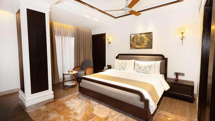 Image of Superior Room with a bed and a photo frame above it at Auradoon, Dehradun.