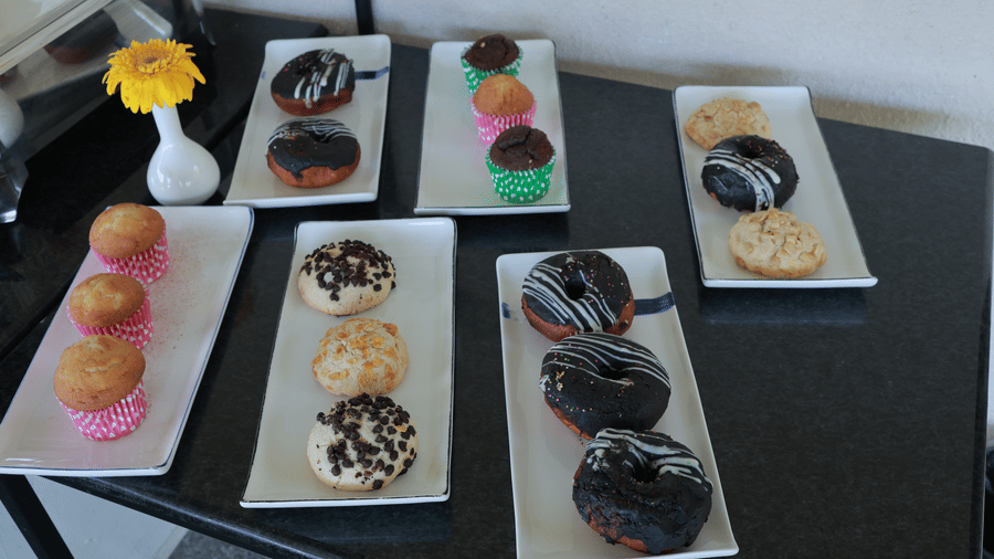 6 rectangular dishes with several dessert items served at the Machaan restaurnat at Aveda Mountains and Mist Resort and Spa, Munnar.