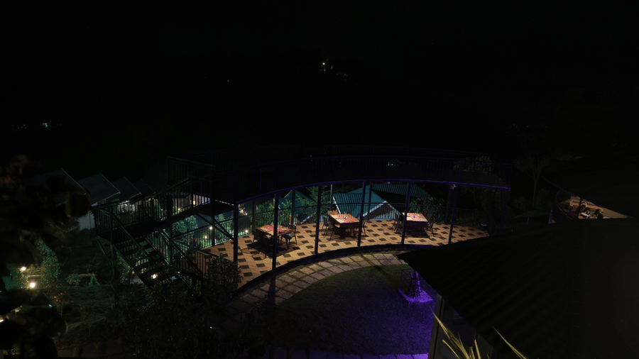 The outdoor dining area of the Machaan restaurant taken from an elevated area at Aveda Mountains and Mist Resort and Spa, Munnar, during the night.