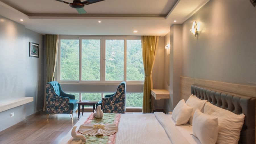 Premuim room with bed, ceiling fan and sewating area at  Avianna Ganagtok Resort and Spa