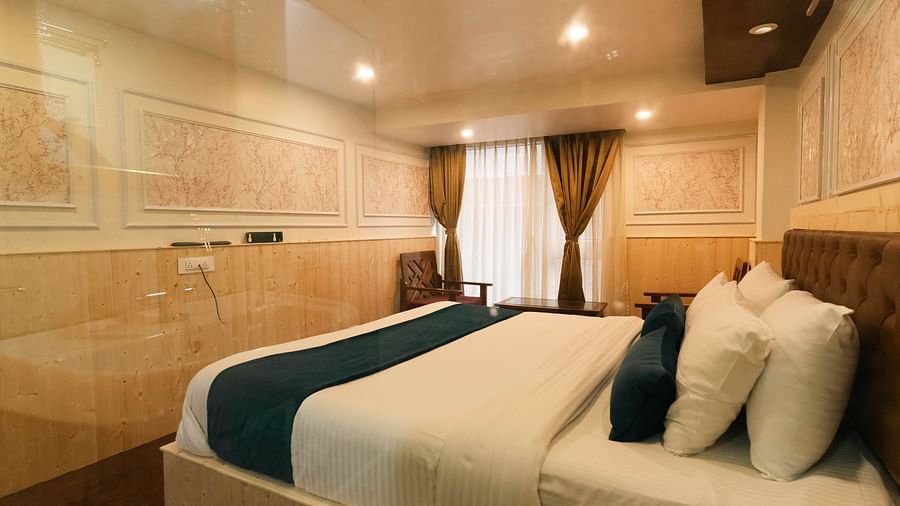an image of a bedroom with carved walls at Avianna New Mandala Hotel & Spa, Darjeeling.