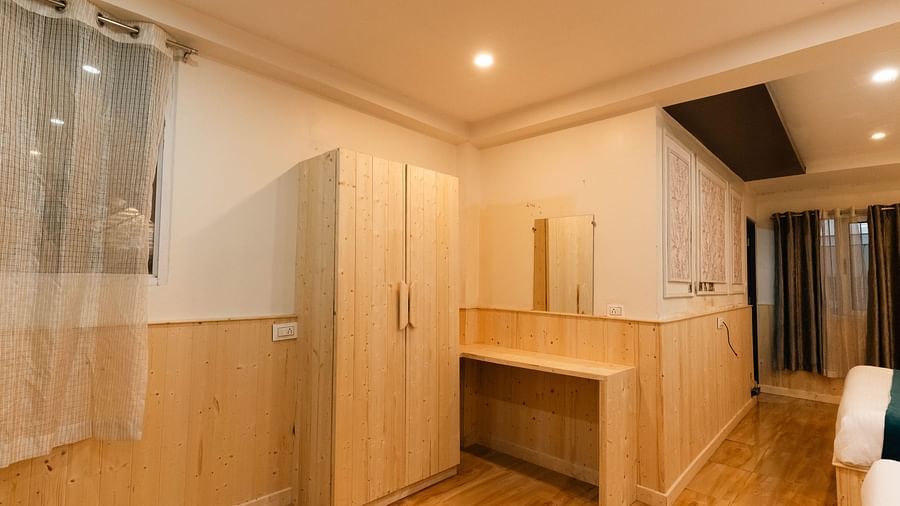 an image of a wooden wardrobe inside a room at Avianna New Mandala Hotel & Spa, Darjeeling.