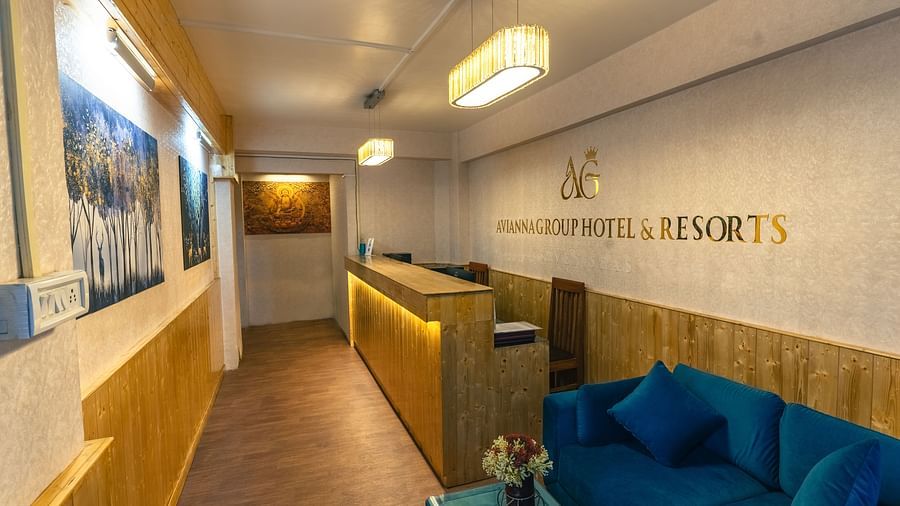 Reception area with warm welcoming lighting and wooden furnitures at Avianna Seven Seas, Darjeeling2