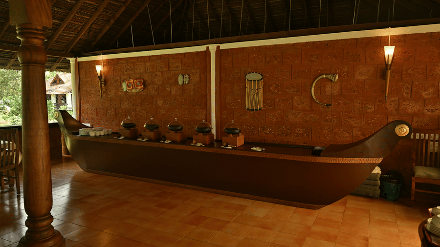 A view of a buffet table in the shape of a boat inside the restaurant at Ayur On The Beach Nattika.