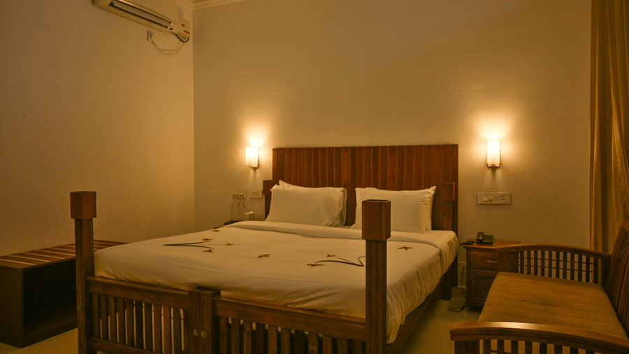 A view of a bedroom inside a villa with side lamps at Ayur On The Beach Nattika.