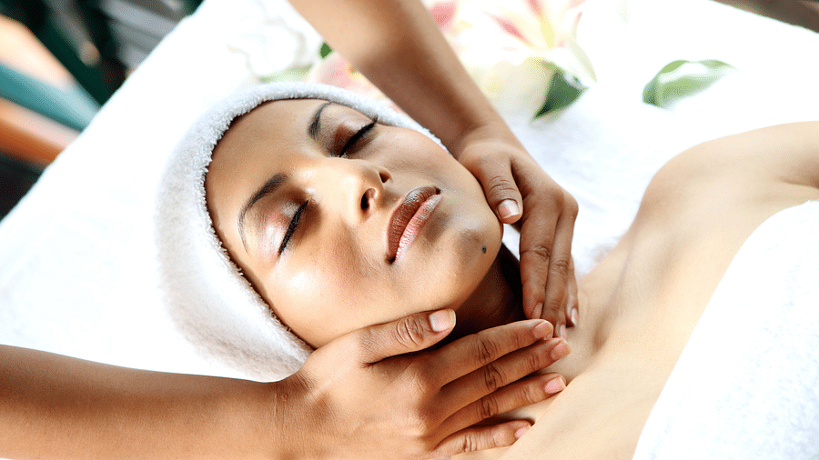 A women is relaxing and having facial massage done.
