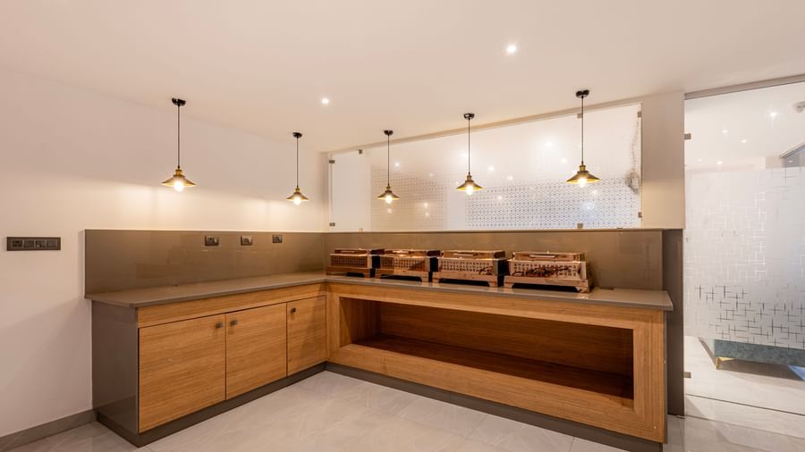 A modern buffet area wooden counter and contemporary pendant lighting - Beestay Hotels Financial District, Hyderabad 