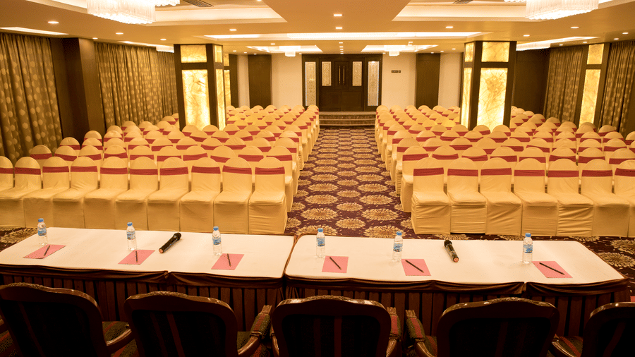 A large meeting room at Benzz Park Chennai with rows of chairs and a long table at the front, indicating a presentation setup.