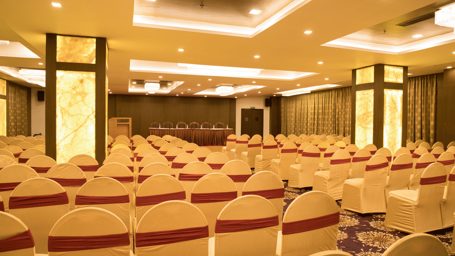 A large conference or banquet hall at Benzz Park Chennai set up with rows of chairs, ready for an event or presentation.