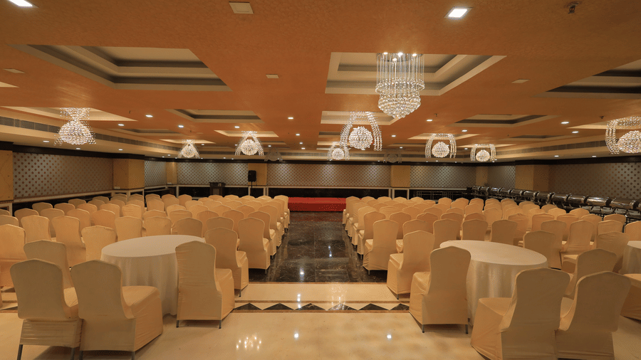 A wide-angle shot of the Rovver hall at Benzz Park, Vellore, with chairs facing towards the centre stage.