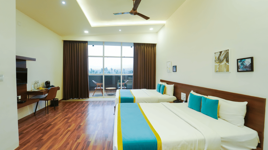Executive Suite at Bindiga Peak Resort featuring 2 double beds, wood flooring, and large glass door leading to the balcony.