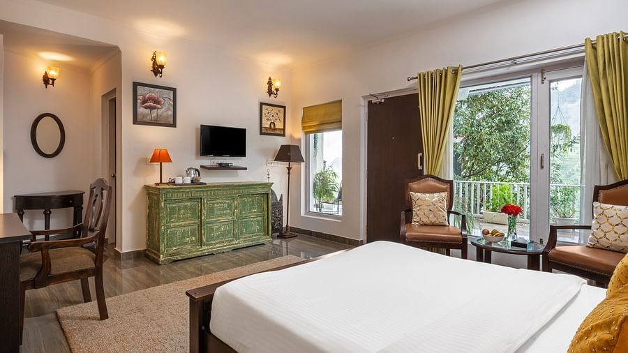 Bright and elegant guest room with large windows, wooden furniture, and modern decor, at BluSalzz Collection - Suvaasa Resort, Ramgarh.