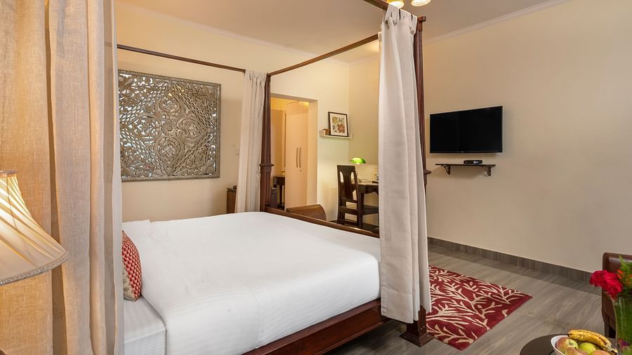 Comfortable suite with elegant furnishings, canopy bed, and flat-screen TV, at BluSalzz Collection - Suvaasa Resort, Ramgarh.