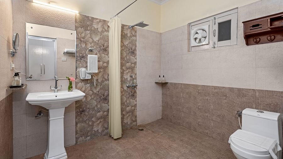 Spacious bathroom with essential amenities and natural lighting at BluSalzz Collection - Suvaasa Resort, Ramgarh.