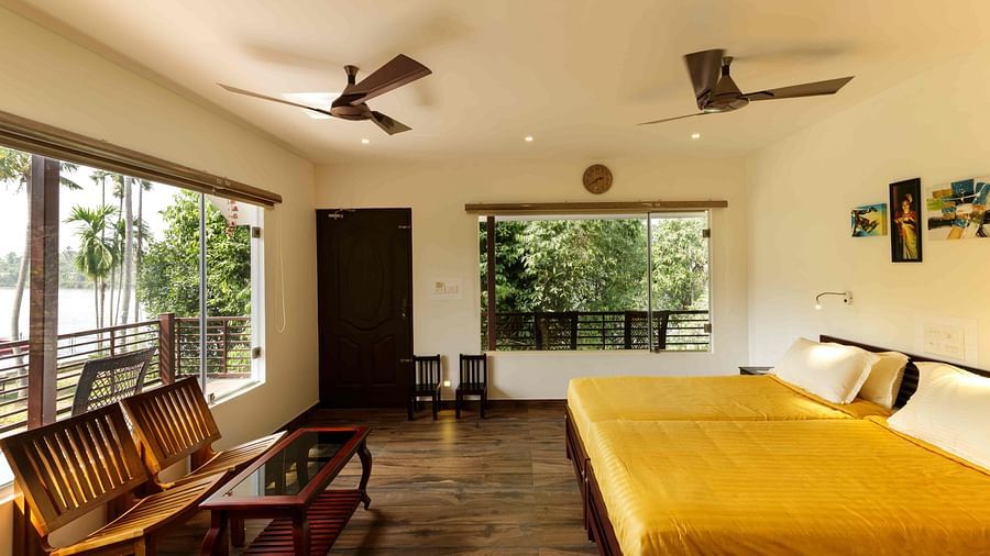 A bedroom with a bed, wooden furniture, and a view of the outside.