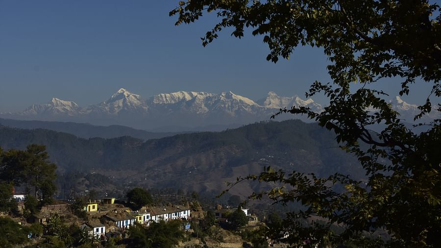 A scenic view of snow-capped mountains and a serene village - BluSalzz Escapade - Anant Rasa Resort
