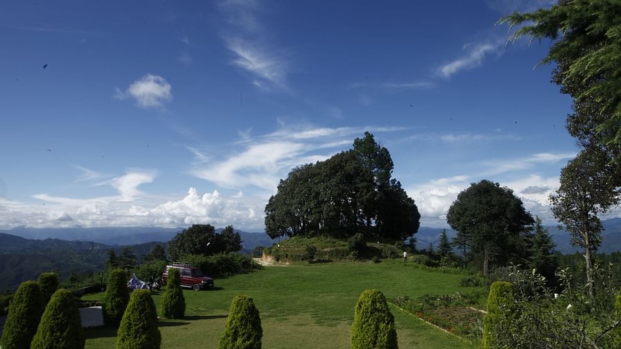 A vibrant wedding lawn in Almora with a scenic backdrop of hills and trees - BluSalzz Escapade - Anant Rasa Resort