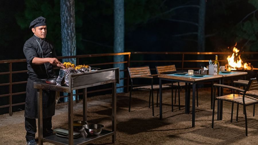 Chef performing a live barbecue session in the garden at BluSalzz Escapade Resort, Lansdowne.