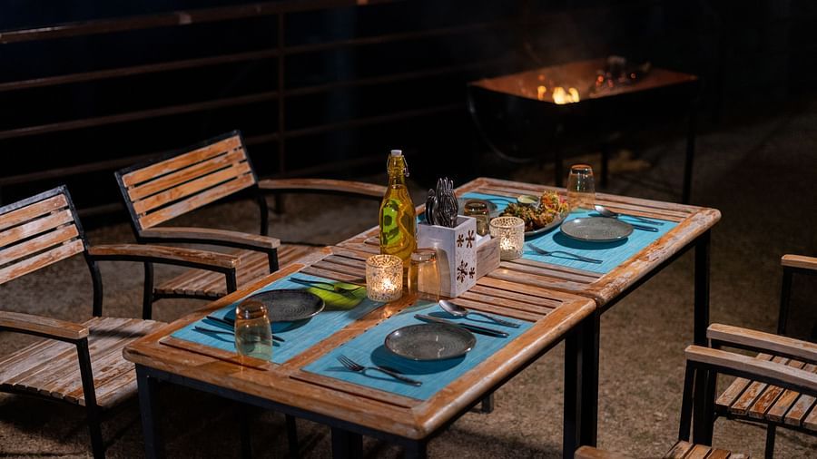 Outdoor dining space in the evening featuring chairs and a table at BluSalzz Escapade Resort, Lansdowne.