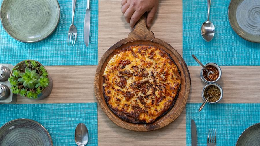 A fresh pizza served hot with toppings at BluSalzz Escapade Resort, Lansdowne.
