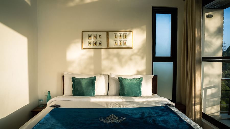 A bedroom with sunlight streaming through the windows at BluSalzz Escapade Resort, Lansdowne.