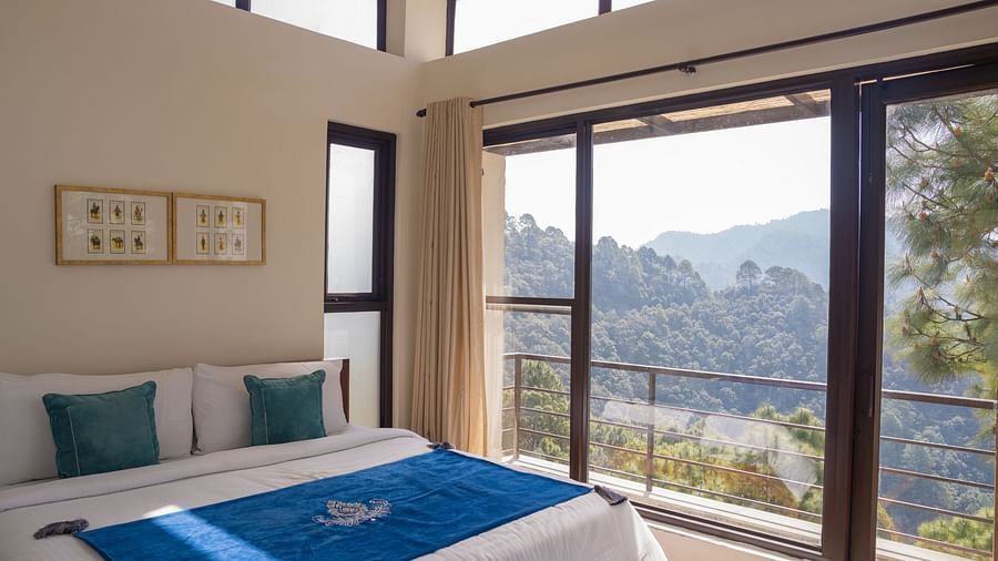 A  bedroom with pillows and a balcony at BluSalzz Escapade Resort, Lansdowne
