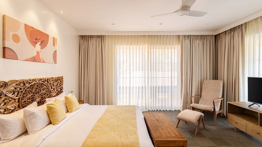 A luxurious bedroom with soft furnishings, a large bed, and vibrant artwork, exuding warmth and comfort - BluSalzz Villas - Alocassia, Anjuna