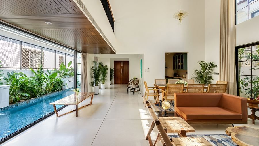 A tranquil poolside space with sleek architecture and tropical plants creating a refreshing environment - BluSalzz Villas - Alocassia, Anjuna